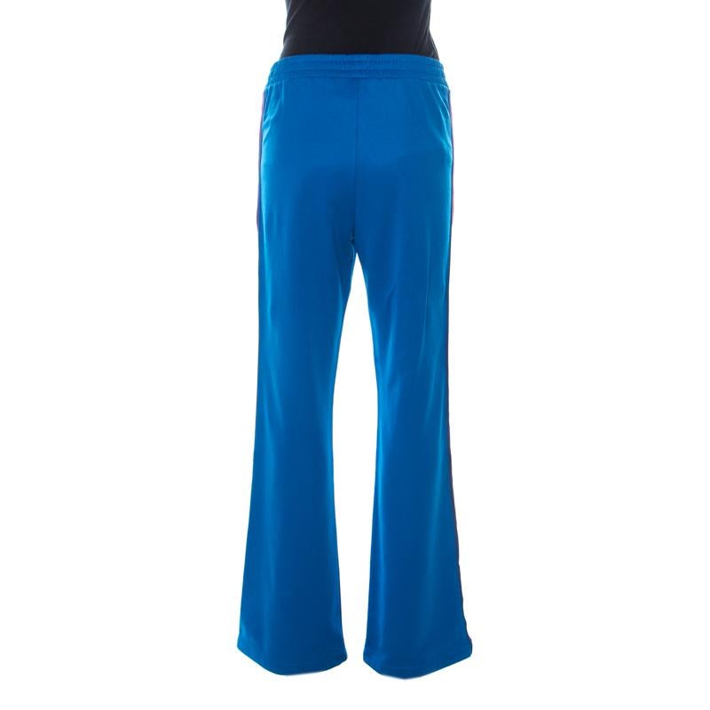 Get a comfortable and cool look in these sweatpants by Gucci. Made from a blend of fabrics in a bright blue hue, these pants feature an elasticised waistline, along with contrasting red trims on the side seams.

Includes: The Luxury Closet