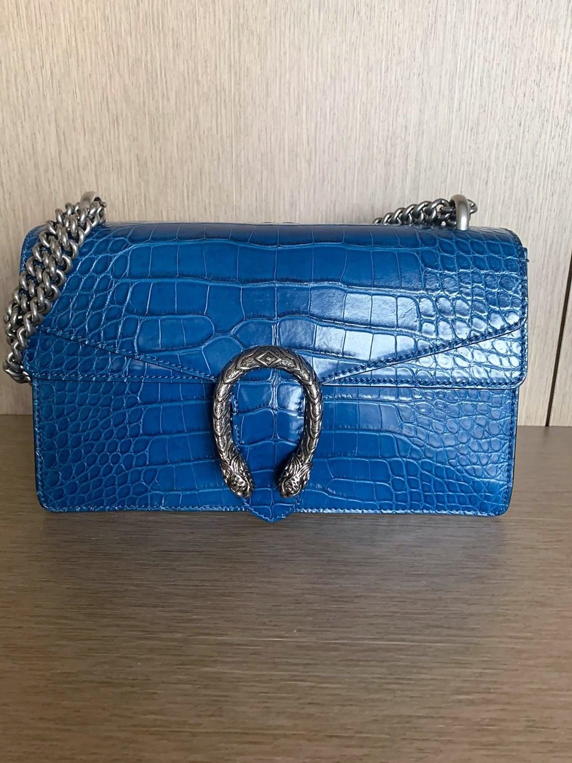 Amazing and super rare Gucci crocodile bag
Model Dyonisus, year 2016
Color Agata Blue
Real crocodile
Palladium tone hardware
Tiger head pin closure with side release
Hand painted borders
Sliding chain strap, can be worned as shoulder strap or as top