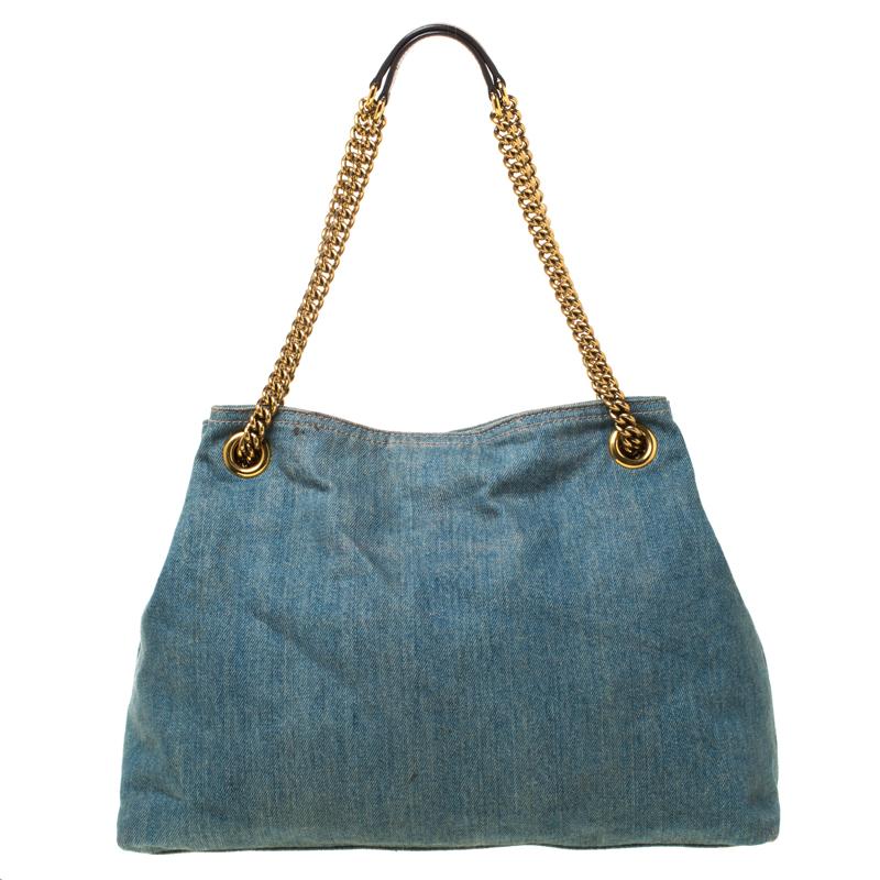 This Soho tote is one of the many designs by Gucci that is loved by women worldwide. The bag is constructed from denim canvas and designed with the signature GG on the front. It features a spacious canvas interior for your essentials, two chain