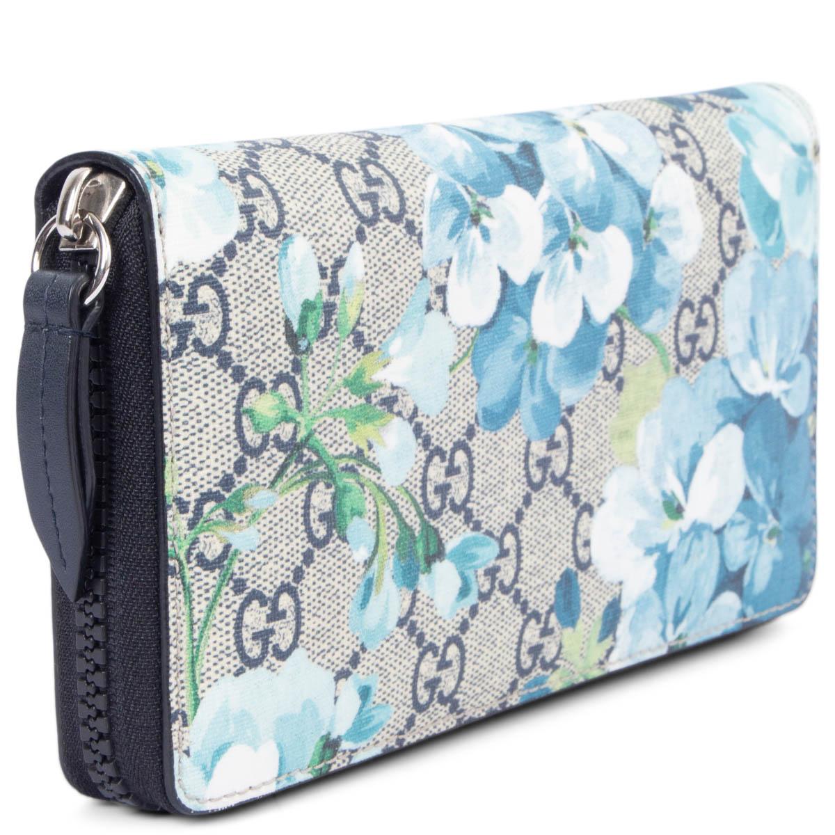 100% authentic Gucci GG Blooms Supreme Monogram Canvas flower print zipper wallet in navy blue, ivory, petrol blue, light blue and green. Lined in navy blue leather with twelve credit card slots three bill compartments and a zipped coin pocket in