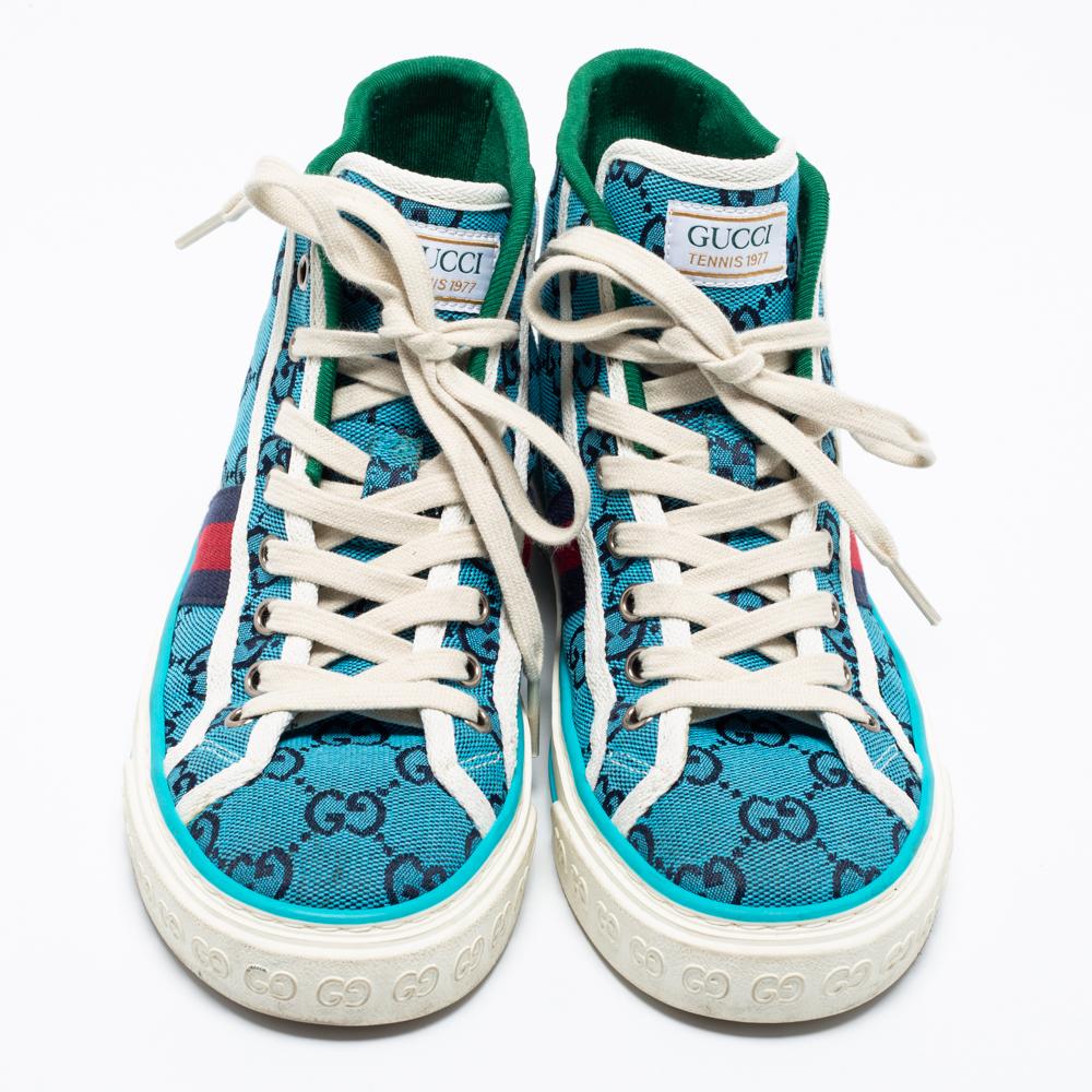 Stacked with signature details, this Gucci pair is crafted using GG canvas into a high-top design with lace-up vamps. The sneakers have been fashioned with a striking blue hue and have Web stripes on the sides. Complete with sturdy rubber soles,