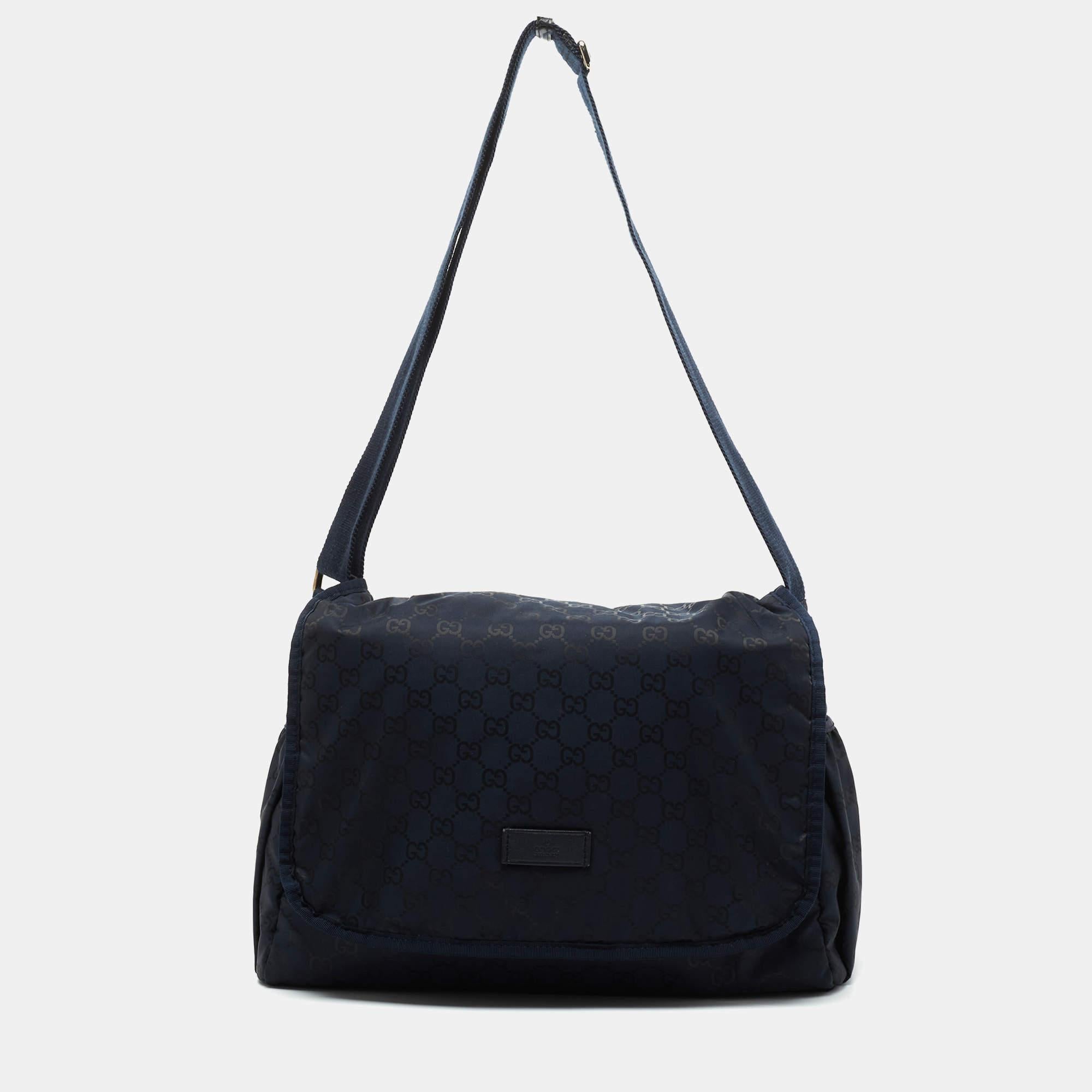 Smart and functional, this bag from Gucci ranks high on style. It has been made from the signature GG nylon and features a front flap closure. The bag is equipped with an adjustable shoulder strap and a spacious nylon-lined interior that can easily