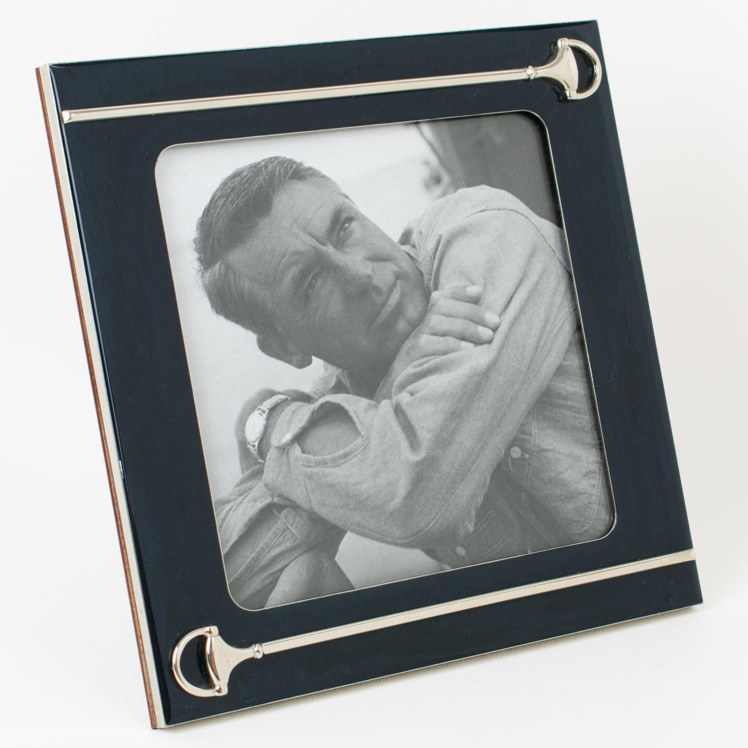 The Italian designer Gucci crafted this luxury lacquer and silver plate metal picture frame. The piece was crafted in Italy circa 1970. The polished silver-plated metal framing is topped with a navy blue lacquer finish and decorated with silver