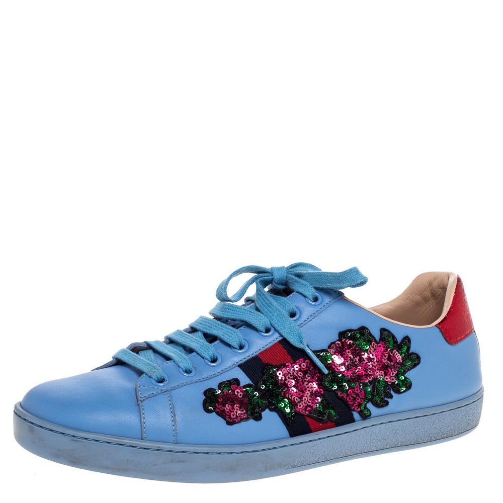 Stacked with signature details, this Gucci pair is rendered in blue leather and is designed in a low-cut style with lace-up vamps. They have been fashioned with the iconic web stripes and have sequin embellished florals on the sides. Complete with