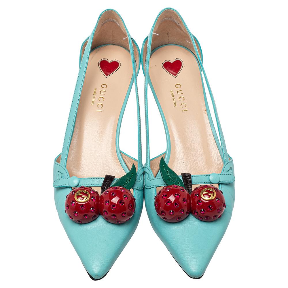 This pair of Gucci pumps is laid with red cherry motifs on a blue leather exterior, thus creating a visually pleasing result. The designer pumps feature pointed toes, leather lining, and bamboo-style heels.

Includes: Original Dustbag, Original Box,