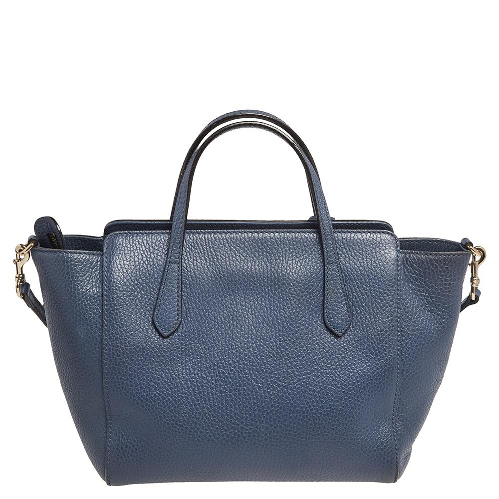 High in appeal and style, this designer tote is a Gucci creation. It comes crafted from leather in Italy and is designed with two handles, a spacious fabric interior, and the brand label on the front. This tote is ideal for everyday use.

Includes: