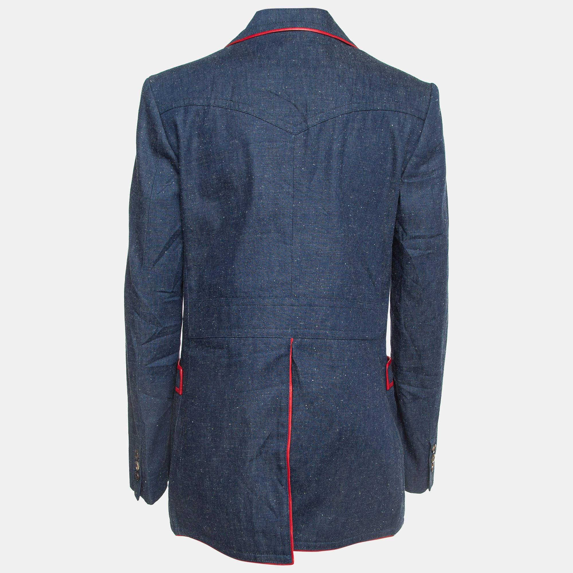 The Gucci blazer embodies sophistication with its sleek design and impeccable craftsmanship. Crafted from high-quality denim, it features luxurious leather trims, adding a touch of elegance to its classic single-breasted silhouette. Ideal for