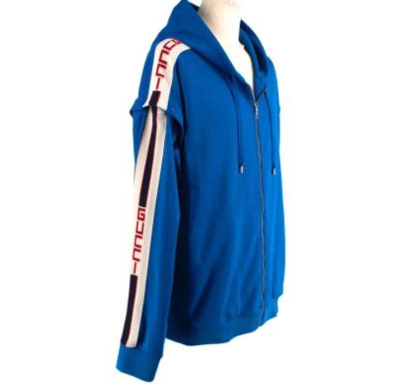 Gucci Blue Logo Side Stripe Track Jacket with Poppers

- Electric blue hooded track jacket 
- Detachable sleeves 
- Front zip-up fastening 
- Two side pockets
- Side stripe with logo and 
- Ribbed cuffs and hem 


Materials: 
55% Polyester
45%