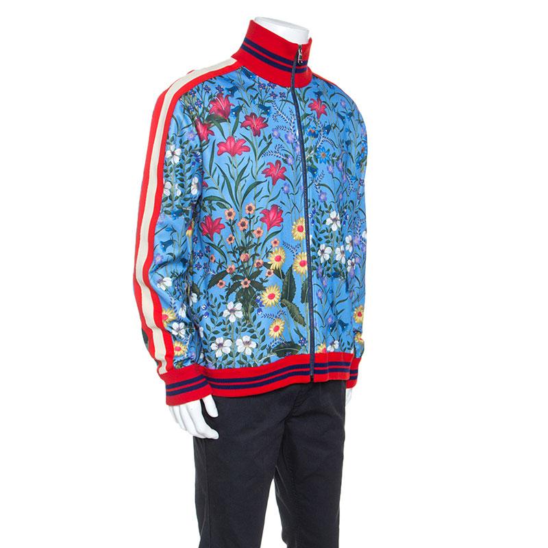 Gucci's spin on a regular sportswear silhouette shines with this track jacket. The blue creation has been made from quality fabrics and designed with signature web stripes, full front zipper and floral prints all over. The jacket essays both comfort