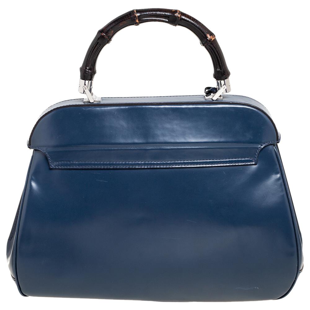 From the House of Gucci, this Lady Lock bag is a grand fusion of brilliance and timeless style. It is fashioned in blue patent leather, with an engraved lock perched on the front. It is decorated with silver-tone fittings, an Alcantara-lined