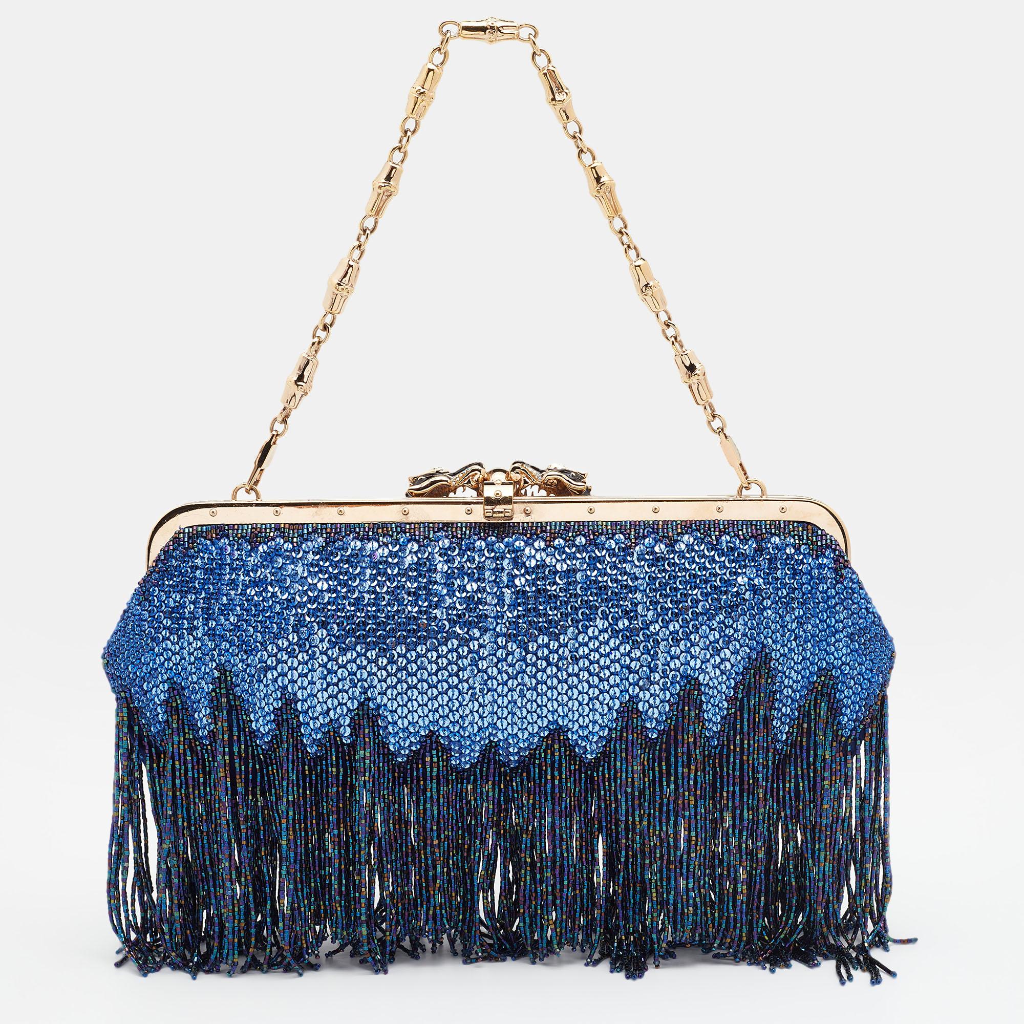 Sequins are carefully sewn all over the exterior, bead fringes are left to dangle from the base, and a dual-dragon accent graces the front — there's nothing we don't love about this Gucci evening bag. It has a gold-tone frame top giving it structure