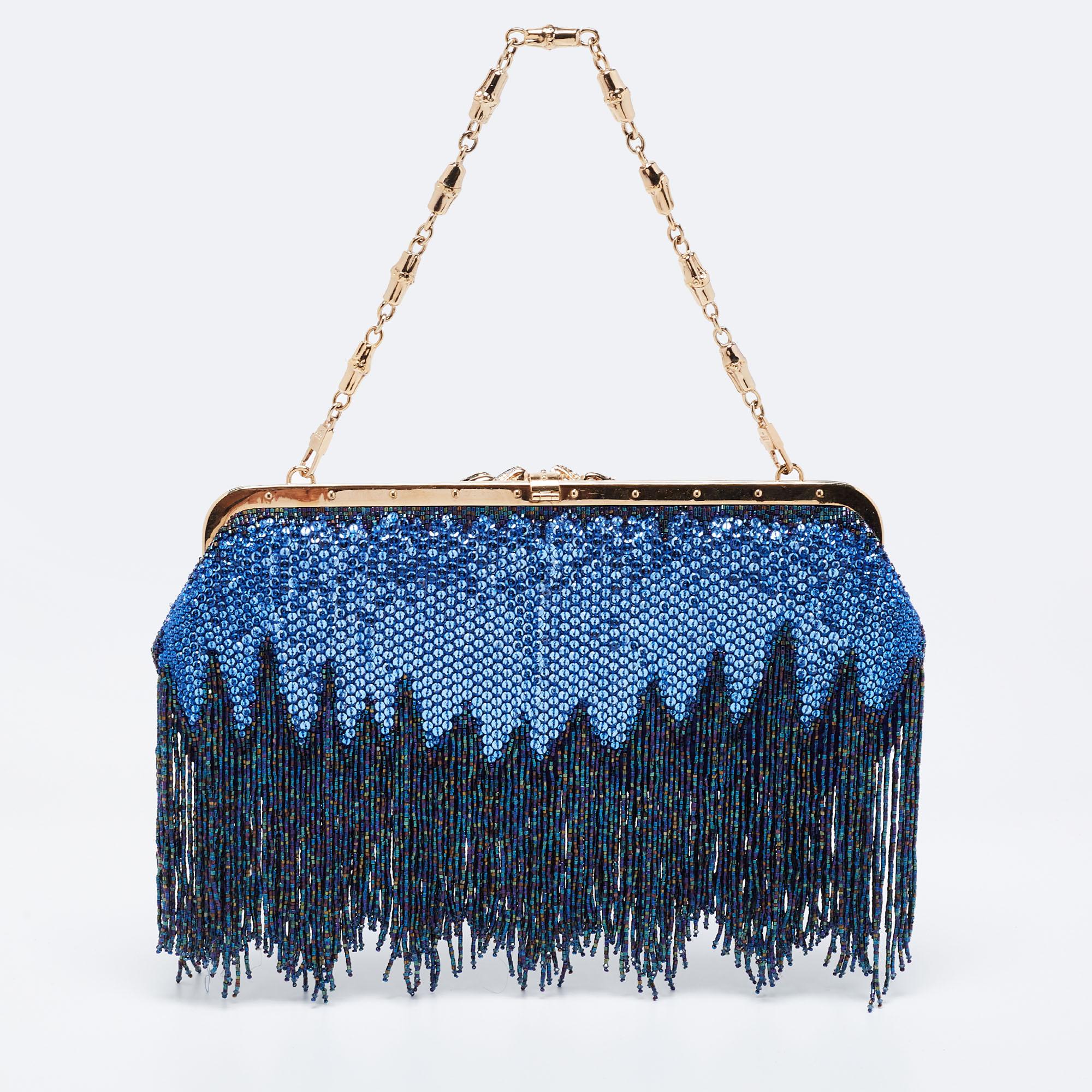 Coming from Gucci is this beautiful creation that is the perfect evening bag. It is crafted from sequins and satin into a structured shape and flaunts gold-tone hardware, fringe detailing, dragon embellishments, a single chain handle, and a roomy