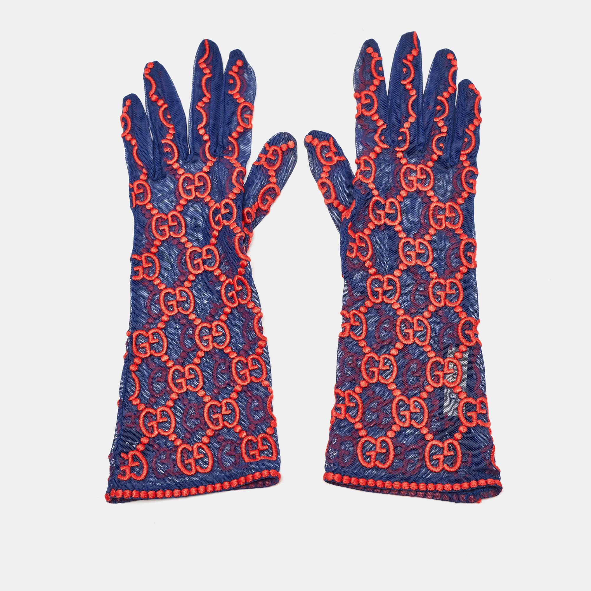 Crafted with meticulous detail, the Gucci gloves exude luxury. Delicate tulle adorned with the iconic GG motif in vibrant blue and red hues creates a striking visual. These gloves effortlessly blend timeless elegance with contemporary flair, making