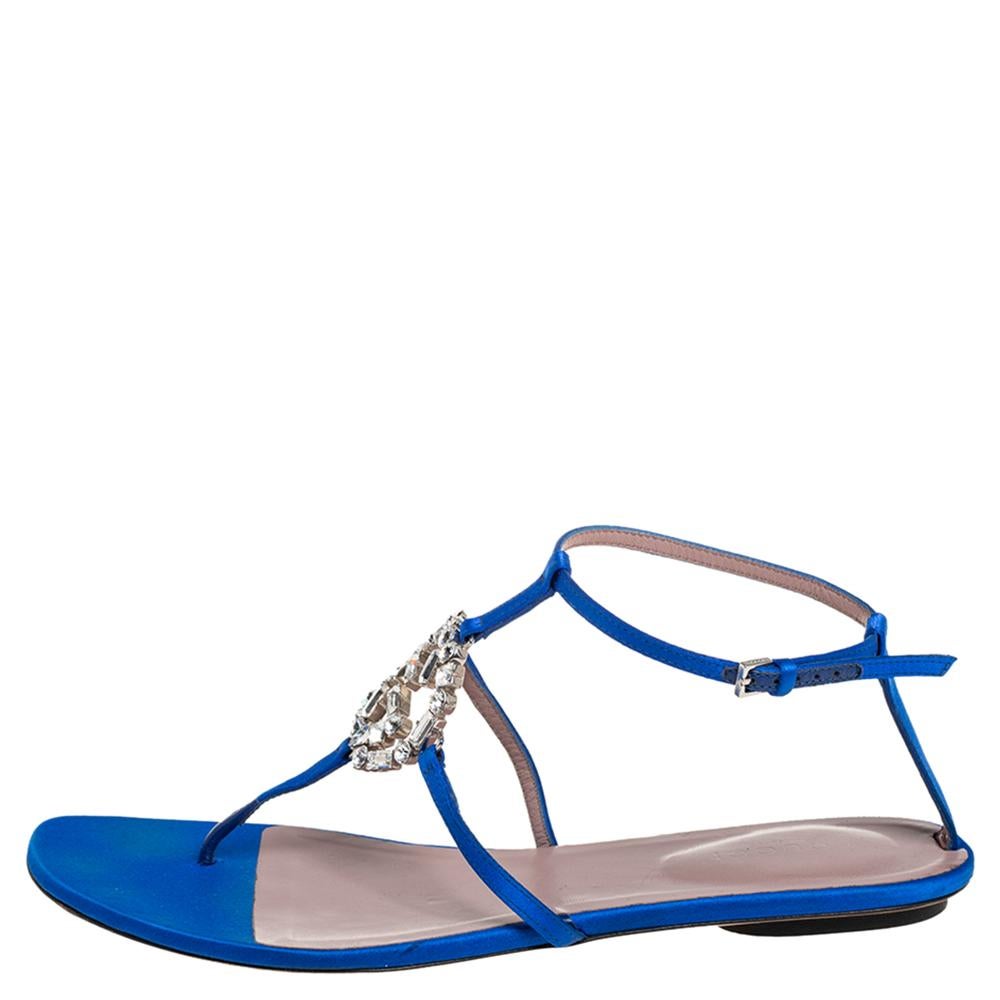 Created with contemporary design sensibilities, these Gucci sandals are perfect for a fashion enthusiast like you. Blue satin is used to create a strappy silhouette that is detailed with a crystal-embellished interlocking GG logo on the vamps. The