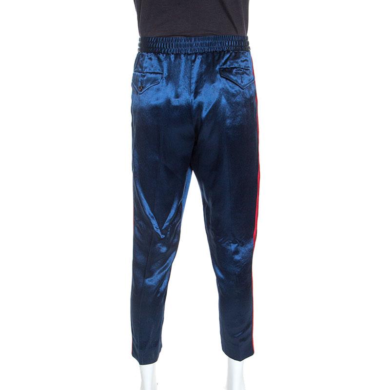 This pair of pants from Gucci is sure to become your favourite as soon as you get them. Made from satin, the pair features web stripes on the sides for a signature touch and a drawstring to fasten the waist. Add a dash of blue to your look with this