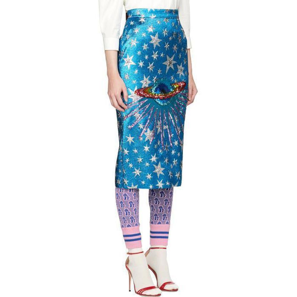 Gucci describes the motifs collection as zigzagging from obscure worlds and cultures - the planet Saturn is depicted on this skirt in scores of shimmering rainbow sequins.
Cut from blue jacquard and woven with silver stars, it has a subtle A-line