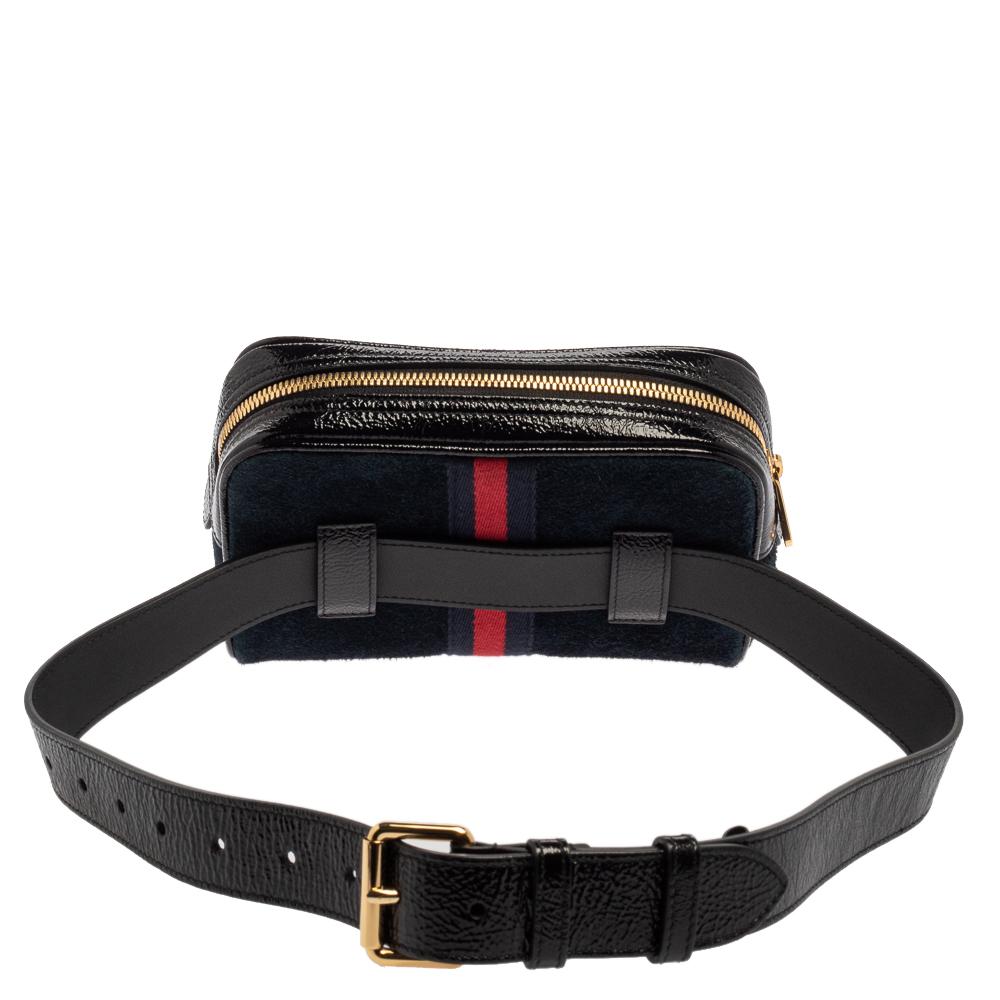 Add class to your look by accessorizing with this Gucci Ophidia belt bag. Designed expertly, this creation features a plush suede body enhanced with patent leather trims. The blue-hued bag flaunts the signature GG logo on the front, along with the