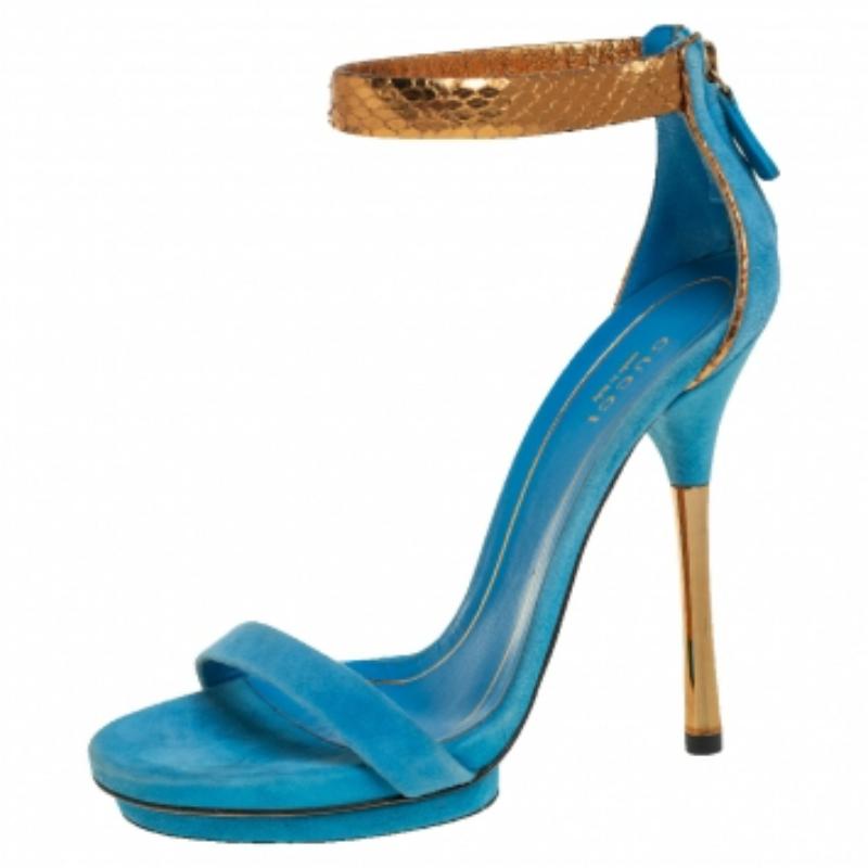 Gorgeous and glamorous, these sandals from Gucci are sure to add sparks of luxury to your wardrobe! These blue sandals flaunt single suede straps on the front, gold python ankle straps, zippers on the heel counters, and 12.5 cm heels. (NOTE: