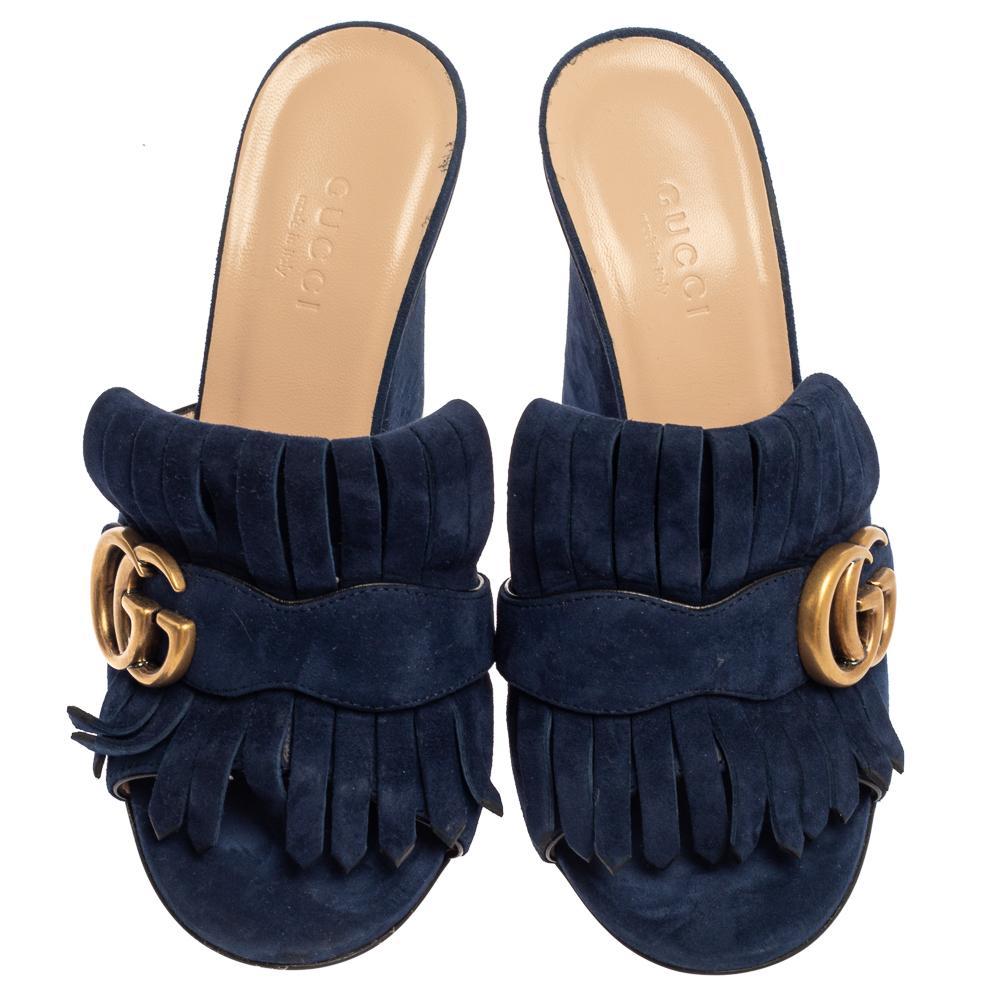 This pair of mules by Gucci is a buy to wear and treasure. They've been crafted from suede and styled with folded fringes with the brand's signature GG on the uppers. Open toes and a set of block heels complete the pair.

Includes: Branded Box