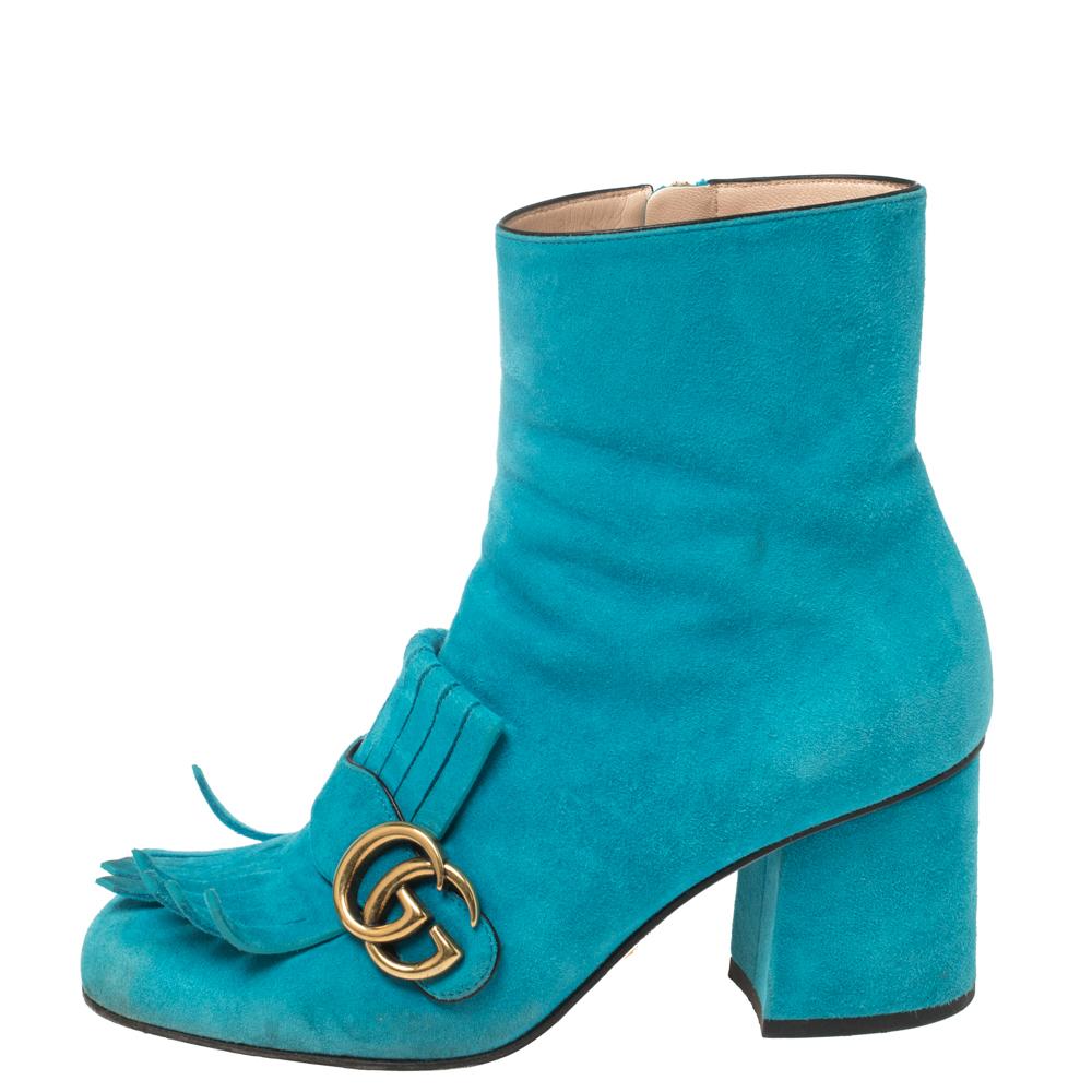 This pair of ankle boots by Gucci is a buy to wear and treasure. They've been crafted from suede and styled with folded fringes with the brand's signature GG on the uppers. Square toes and a set of block heels complete the pair.

Includes: Original