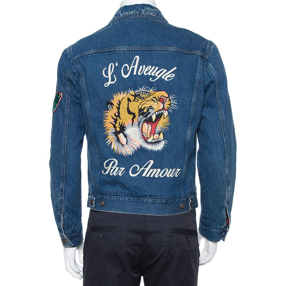 Gucci continues to reinvent the embroidered denim trend with this jacket. With its distinctive embroidered roaring tiger to the back, this creation is the ultimate off-duty pick. It features 'L'Aveugle Par Amour' (Blind For Love) scrawled around the