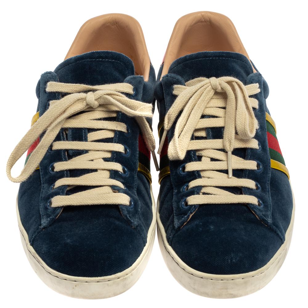 Stacked with signature details, this Gucci pair is rendered in velvet and leather and is designed in a low-cut style with lace-up vamps. The blue sneakers have been fashioned with the iconic web stripes on the sides. Complete with red and green