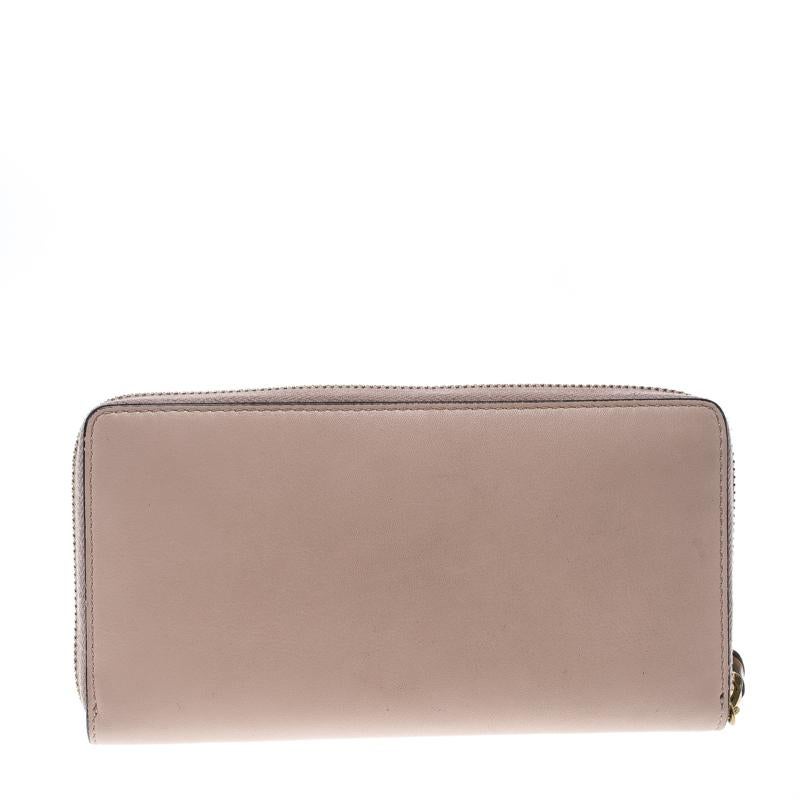 How cute does this zip around wallet from Gucci look! Stunning in blush pink, this wallet is crafted from leather and features a gold-tone top zip closure and a bamboo and pearl accent zipper pull. With a leather and nylon interior, it is perfect to