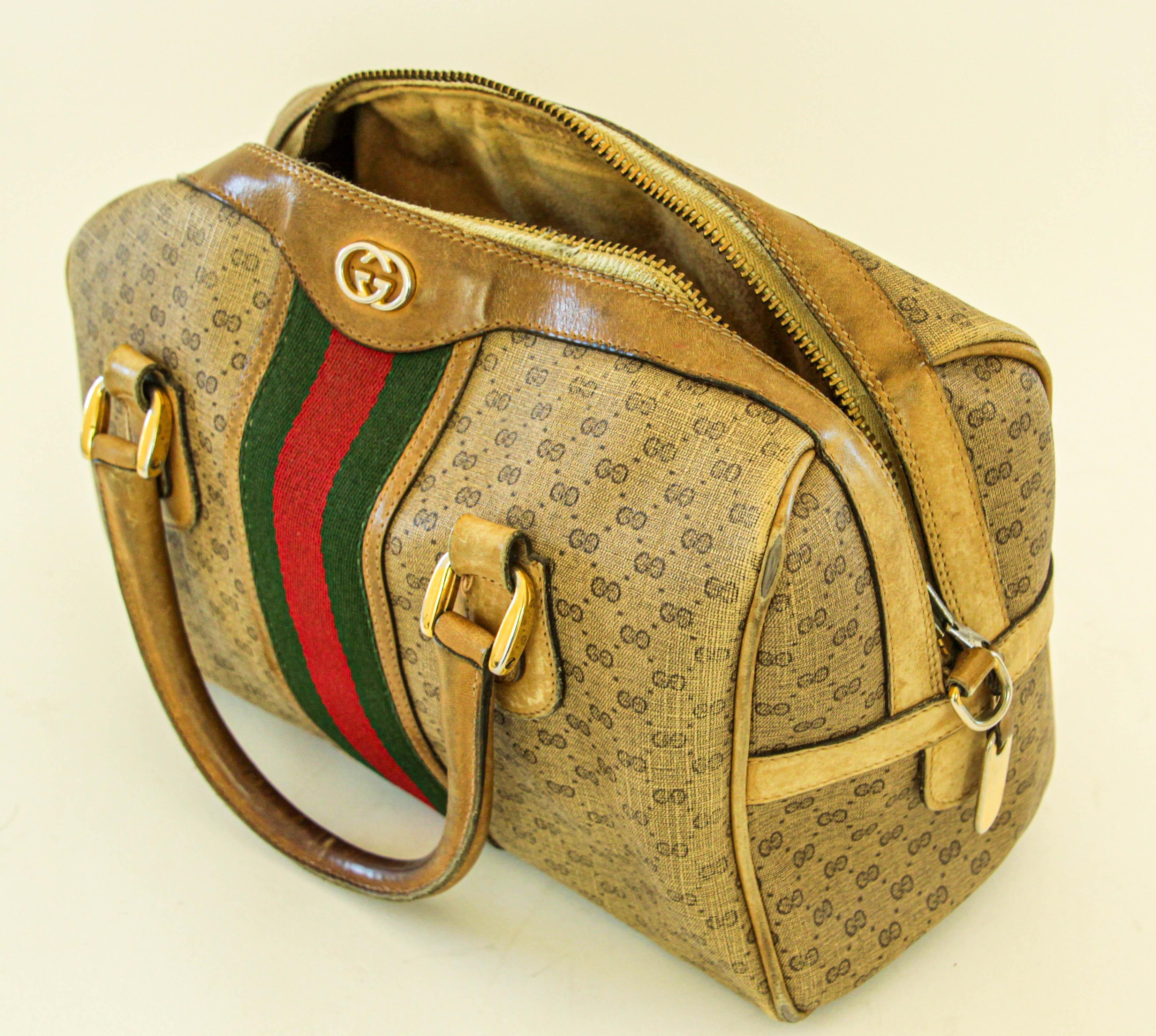 This vintage small Boston bag by Gucci is crafted from canvas with leather details and handles featuring the classic GG print in light brown. This top handle style with the oblong bottom is enclosed with a zip and finished with golden-tone