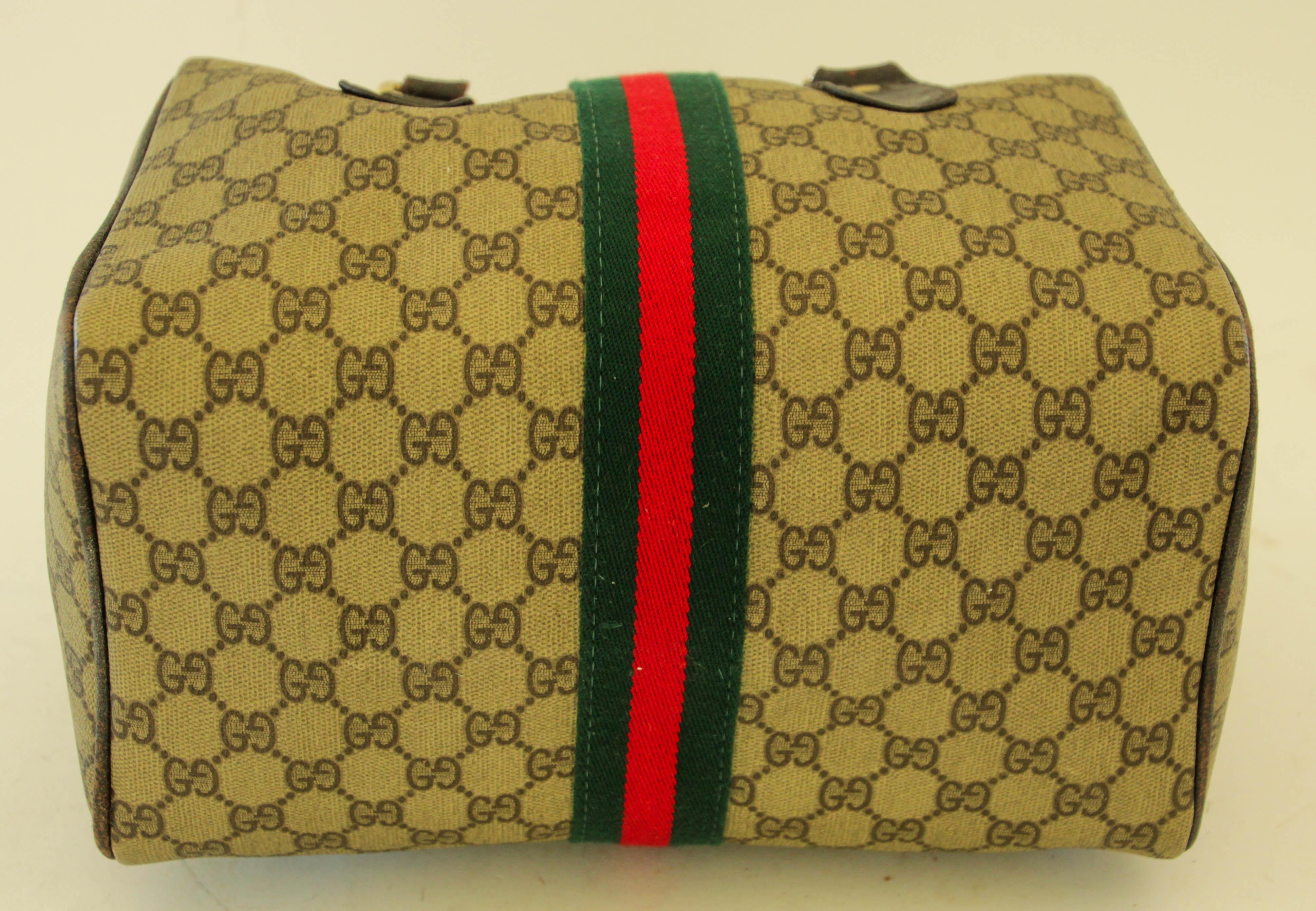 GUCCI Ophidia Boston Bag Web GG Supreme Monogram Vintage Gucci 1970s Gucci Ophidia Boston brown leather handbag.
This vintage small Boston bag by Gucci is crafted from canvas with leather details and handles featuring the classic GG print in dark