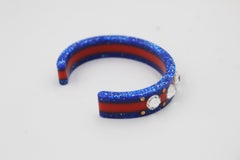 Gucci bracelet in red and blue plastic, with with a bee and rhinestones