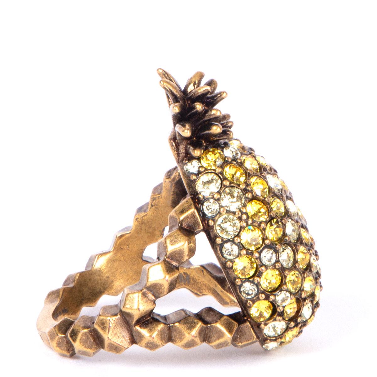 100% authentic Gucci pineapple ring in antique gold-tone brass embellished with yellow and clear crystals. Has been worn and is in excellent condition.

Size 7.5
Width 3cm (1.2in)
Length 3.5cm (1.4in)
Hardware Antique Gold-Tone

All our listings
