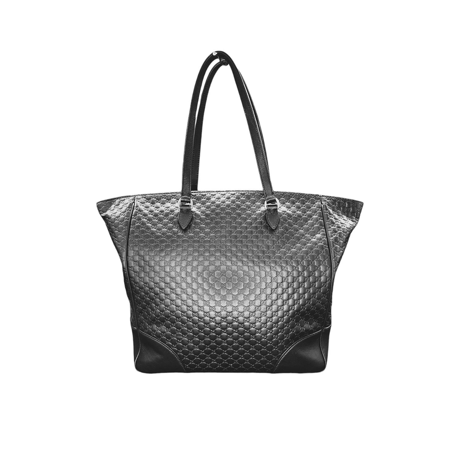 This Gucci Bree Guccissima Medium Leather Tote was made in Italy, and it is finely crafted of black Guccissima leather with black microGuccissima leather corners and leather trim with light gold-toned hardware. It has flat double handles with 7 inch