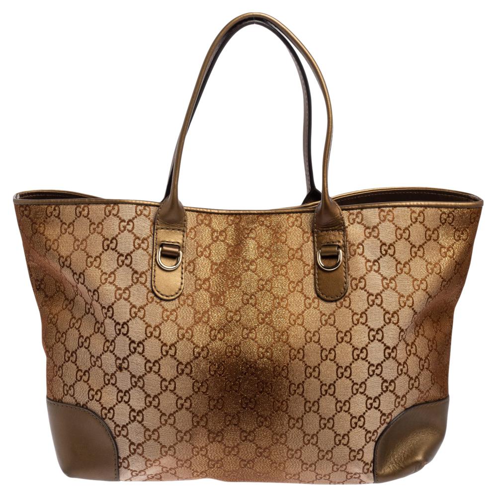 This Heart Bit tote from Gucci has left us smitten with its beauty and style. It comes in a beige GG shimmer canvas body with brown touches and leather patches on the corners. The tote has a spacious canvas & leather interior, two leather handles, a
