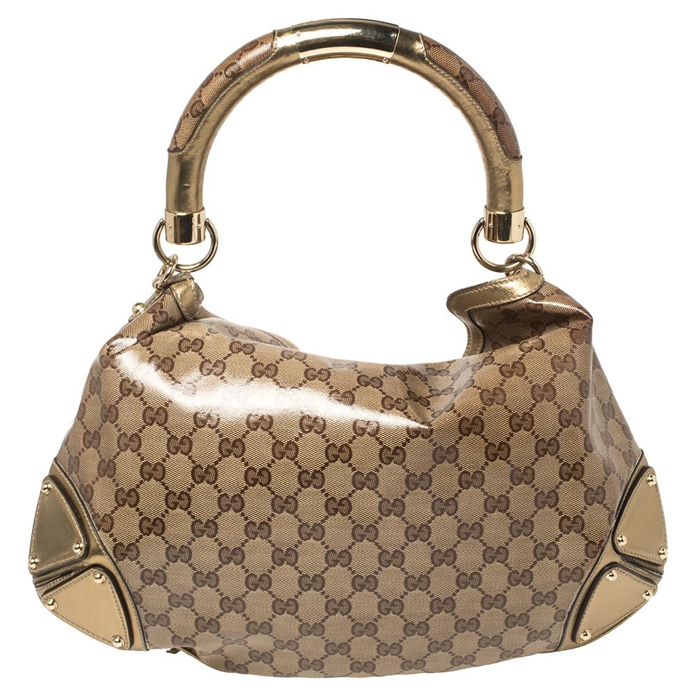 This stunning Indy hobo bag handcrafted in Italy will make a standout addition to your collection. The gorgeous bag is made from Gucci’s GG Crystal coated canvas, it is accented with bamboo detailed tassels and a Gucci engraved single handle. The