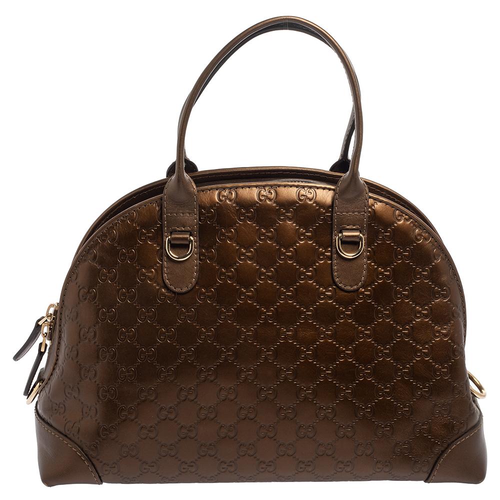 You won’t have to sacrifice style for functionality with this Dome bag by Gucci. Made from bronze Guccissima leather, it features a horsebit and bamboo heart logo charms, rolled leather handles, and a double zip closure. Its spacious interior is
