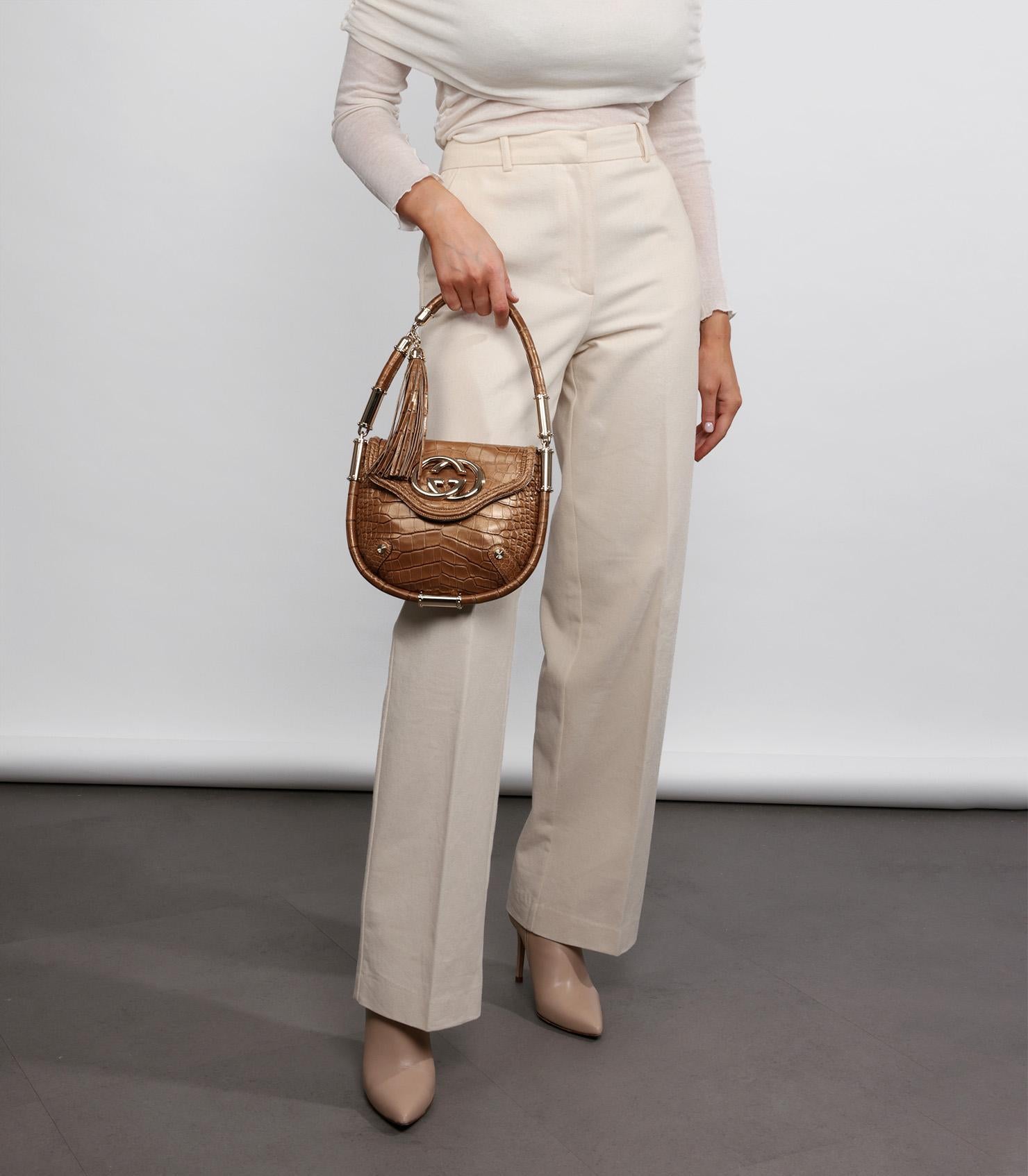 Gucci Bronze Metallic Alligator Leather Vintage Britt Tassel Flap Bag

Product Details
Xupes Ref: CB1213
Brand: Gucci
Model: Britt Tassel Flap Bag
Type: Top Handle, Shoulder
Serial Number: 167733 001998
Accompanied By: Gucci Dust Bag
Colour: