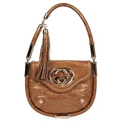 Bolso Gucci con solapa de borla Vintage Britt de piel de cocodrilo metalizada en bronce