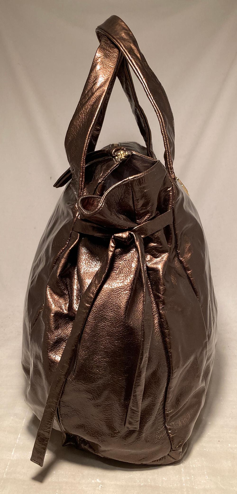 Gucci Bronze Patent Leather Hysteria Bag in excellent condition. Metallic bronze patent leather exterior trimmed with gold hardware, double top handles, front round Gucci medallion in gold, unique side ties and coveted Hysteria design. . Top zipper