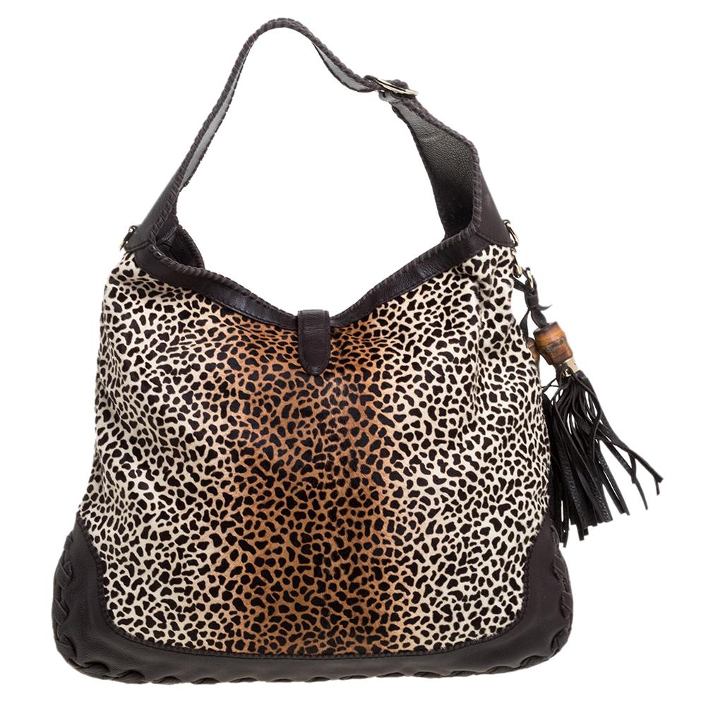 This Gucci hobo will never fail you. Crafted from animal printed calf hair and leather in Italy, this gorgeous number has the signature bamboo closure with gold-tone hardware and opens up to a spacious leather interior. Complete with a single handle