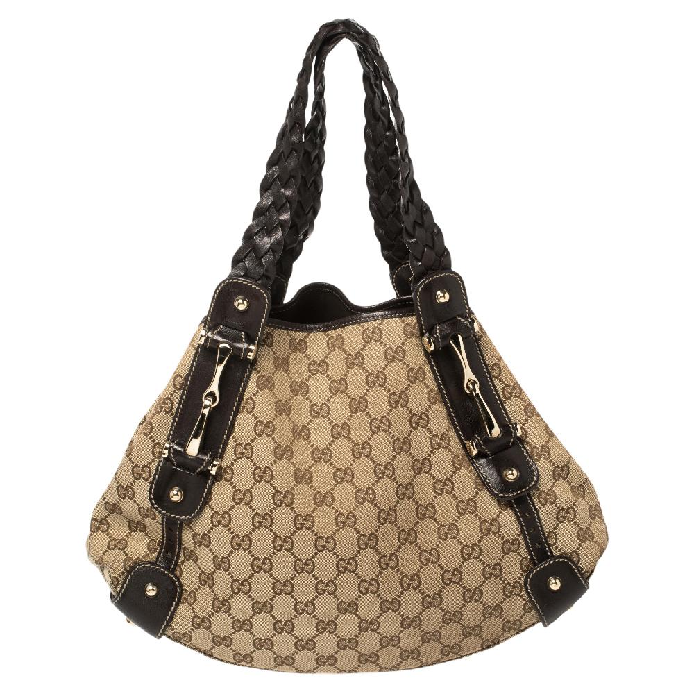 This Gucci Pelham shoulder bag for women comes fashioned with GG canvas and leather. It has a spacious size and durable construction. The designer bag is lined with fabric and held by two woven handles.

Includes: Original Dustbag, Info Booklet,
