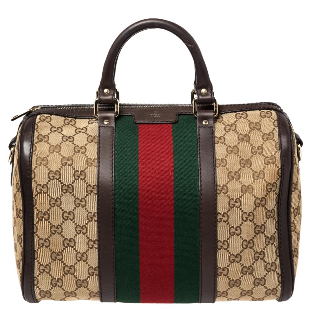 This Gucci Boston bag perfectly blends Gucci’s timeless and iconic style. This bag is made from Gucci’s classic GG canvas in beige, with a brown leather trim that gives it a touch. It features the signature web detail stripes accented with gold-tone