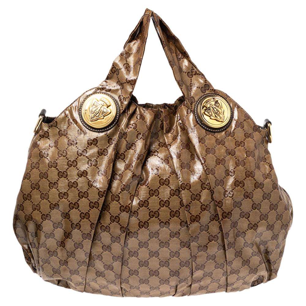 This Gucci hobo is built for everyday use. Crafted from GG Crystal canvas and leather, it has two handles and a detachable shoulder strap for crossbody or shoulder styles. The interior is spaciously sized and the exterior is adorned with gold-tone
