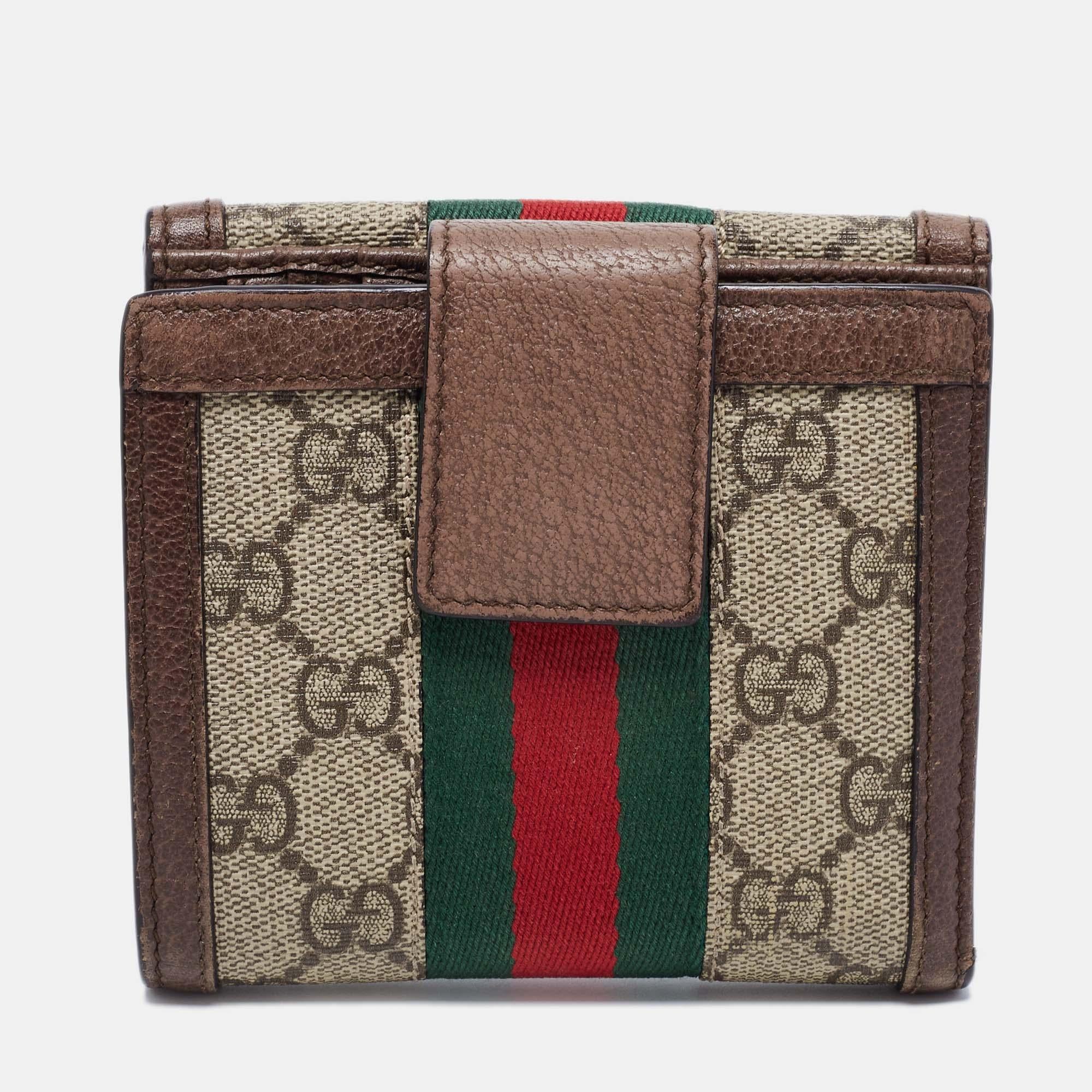 The house of Gucci makes sure you stay at the top of your accessory game with this pretty wallet. Crafted from coated canvas and leather, it has a flap closure and multiple card slots for easy organization. The brown-beige piece is complete with the