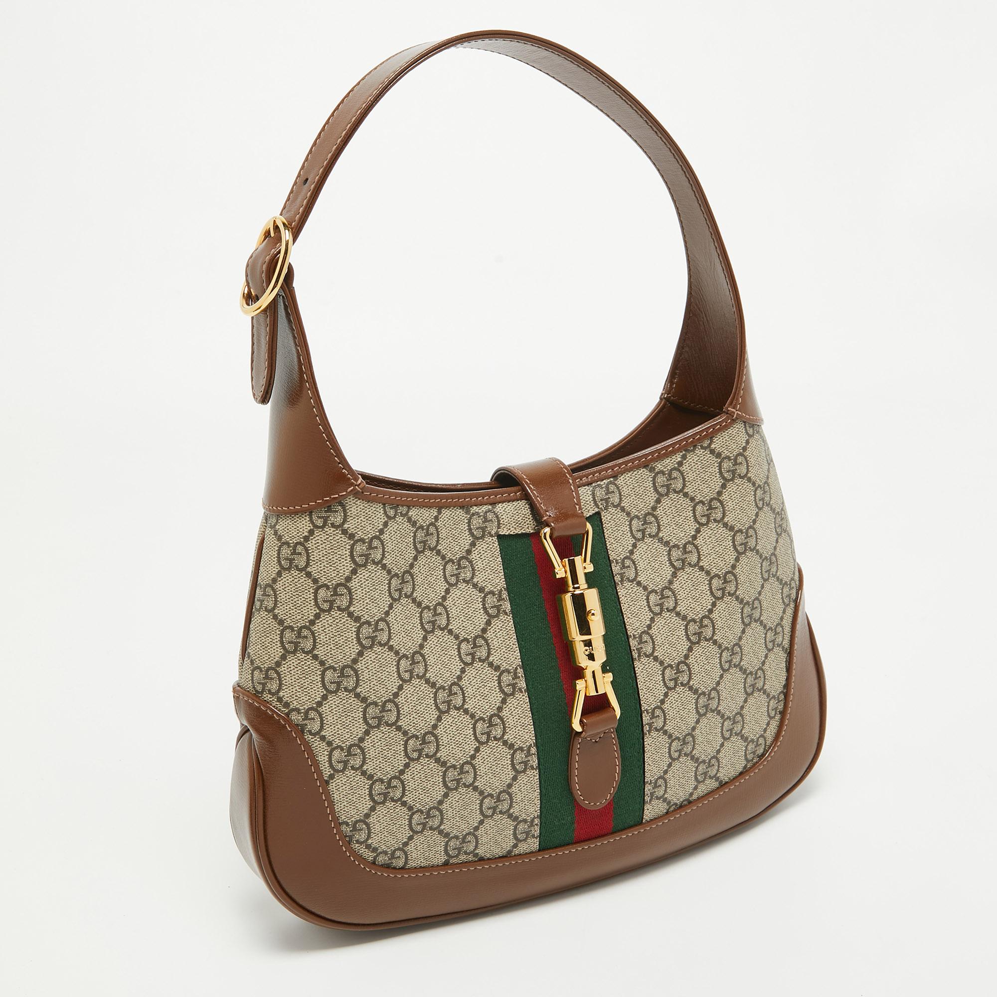 The Gucci Jackie 1961 Hobo exudes timeless elegance. Crafted with the signature GG Supreme canvas and luxe leather, it features the iconic piston closure and a comfortable shoulder strap. Its compact size makes it perfect for carrying essentials