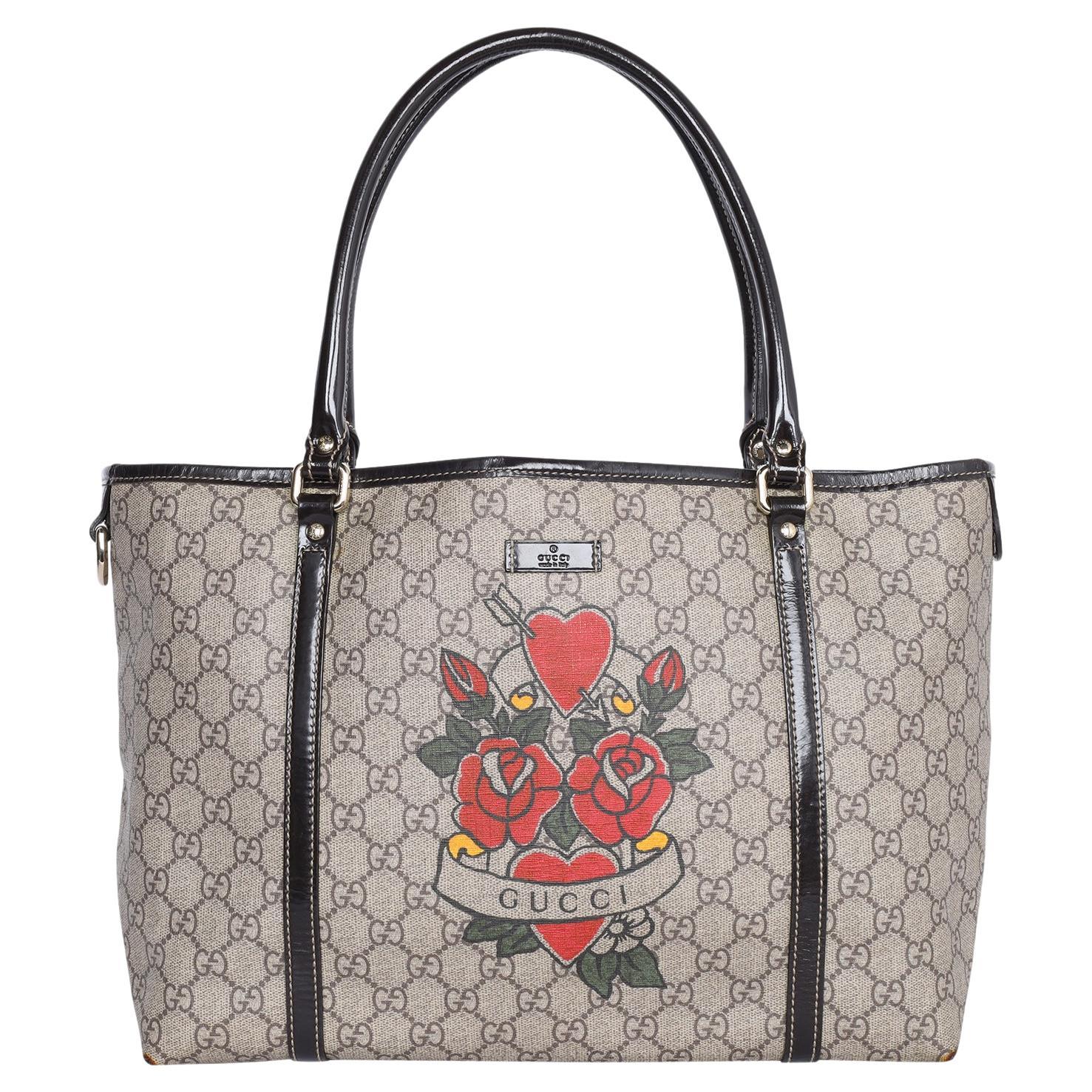 Authentic, pre-loved adorable Gucci Heart Tattoo tote from the Gucci heart tattoo collection. This tote bag perfectly blends Gucci’s timeless and iconic style. This tote features Gucci’s classic GG Supreme canvas and patent leather in beige & dark