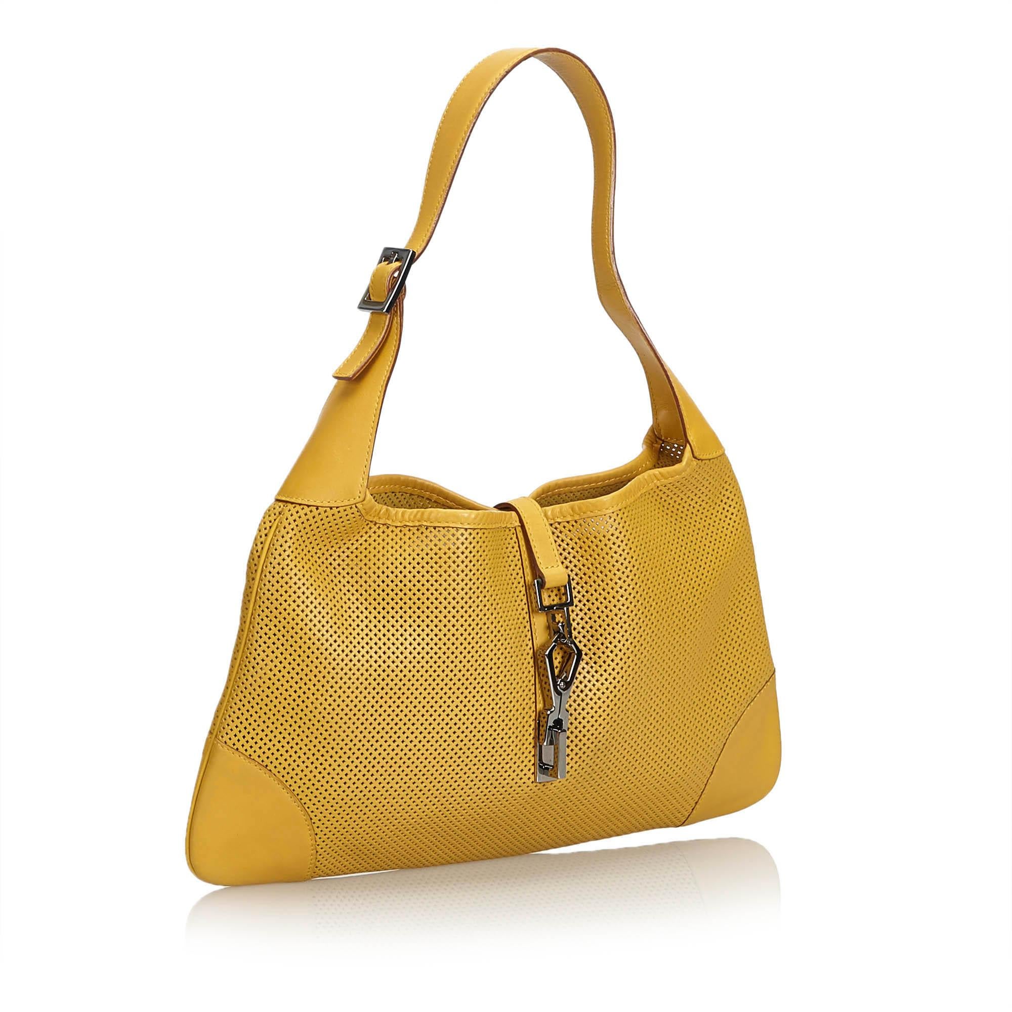 This Jackie features a mesh body with leather trim, a flat leather strap, an open top with a flat strap and a push lock closure, and an interior zip pocket. It carries as B+ condition rating.

Inclusions: 
This item does not come with