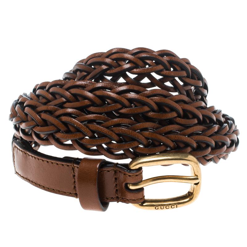 Perfect to add a touch of style and glamour to your look, this brown leather belt from Gucci, crafted in a sleek design, exudes a refined, feminine appeal. It is styled in a braided fashion and features a buckle in gold-tone hardware with the brand