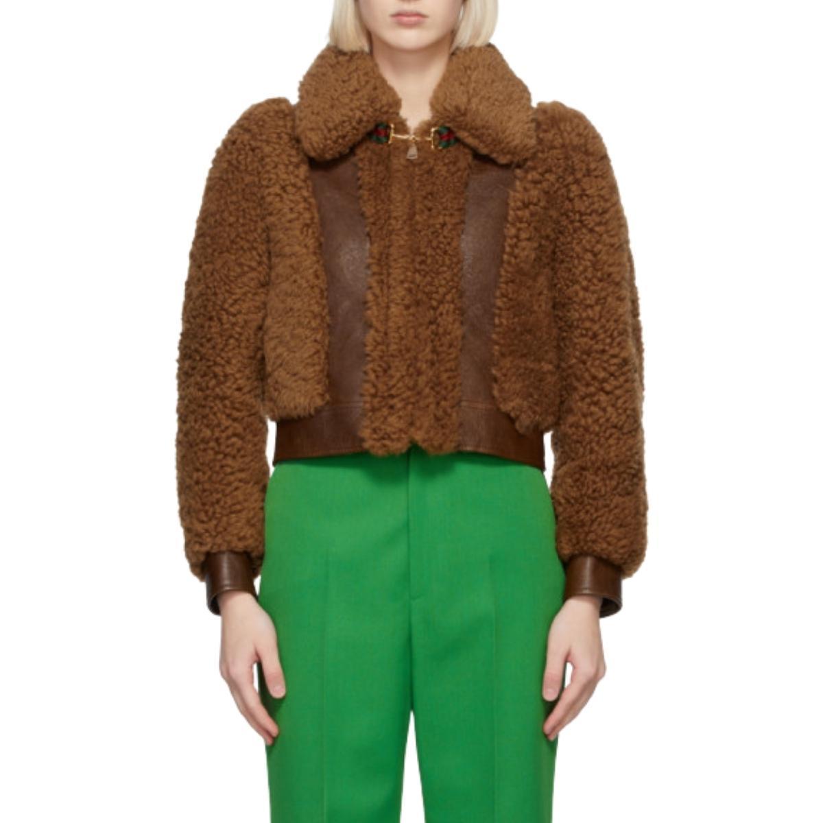 Long sleeve paneled shearling and grained lambskin jacket in brown. 
Grosgrain trim striped in green and red and signature horsebit hardware at spread collar. 
Concealed zip closure at front. 
Single-button barrel cuffs. 
Tonal satin lining. 
Fully