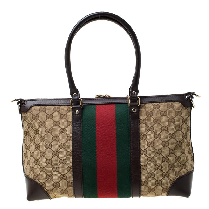 The ever-classic ample tote from Gucci is composed of GG canvas and leather. With the interior lined with fine fabric, this is a fine brew of quality and sophistication. Two handles are attached to the bag and the signature web detail is laid in the