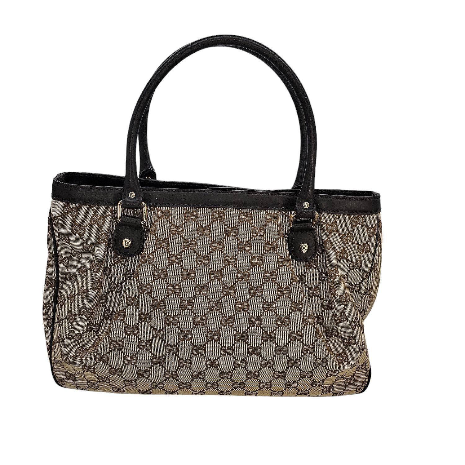 This popular and affordable Gucci GG Canvas Sukey Bag features a chic tote design with leather handles, zipper center compartment closure, as well as a fold-over leather strap, w/ magnetic snap. This bag is made of durable GG canvas. Its roomy